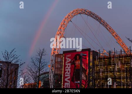 London, UK. 15th Mar, 2020. A fine mist of rain as the sun set on Sunday evening produced a striking rainbow over Wembley Stadiums famous arch, Wembley Park, UK Credit: amanda rose/Alamy Live News Stock Photo