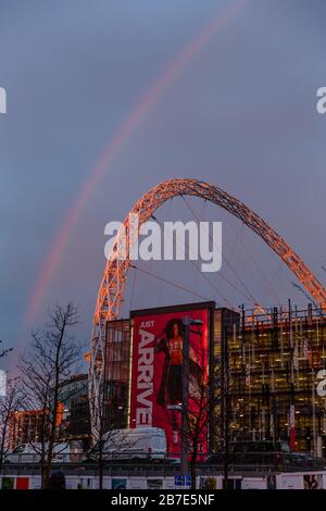 London, UK. 15th Mar, 2020. A fine mist of rain as the sun set on Sunday evening produced a striking rainbow over Wembley Stadiums famous arch, Wembley Park, UK Credit: amanda rose/Alamy Live News Stock Photo