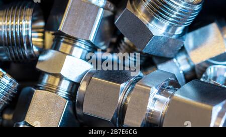 Quick connect fittings coupling for assembling compressed air, hydraulics, pneumatics, gases, fuel lines. Lays in a chaotic manner. Stock Photo