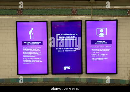 MTA signs display information in Spanish on Coronavirus and to report discrimination, Times Square subway station, New York City, March 15, 2020 Stock Photo