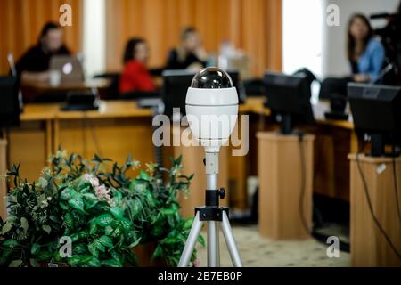 Details with a video camera in the middle of a meeting room. Video conference camera. Stock Photo