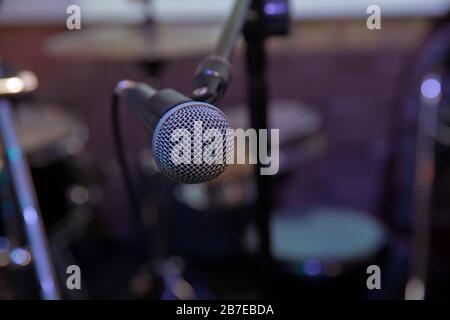 Musical Concept. recording, selective focus microphone in radio studio, selective focus microphone and blur musical equipment guitar,bass,drum piano Stock Photo