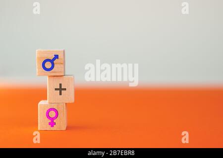 Concepts of gender equality. Wooden cubes with gender symbols sign, traditional family concept. Stock Photo