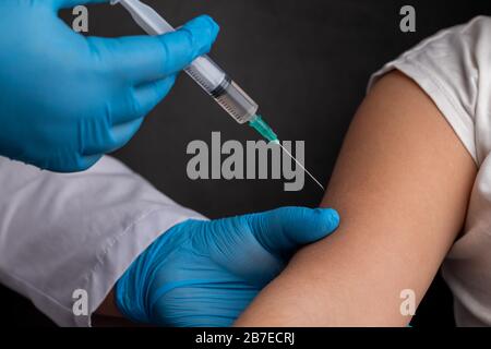 Doctor vaccinates child to stop coronavirus and other pandemic diseases Stock Photo