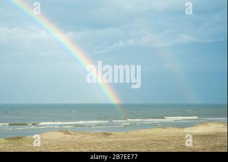 Double rainbow over ocean beach Stock Photo