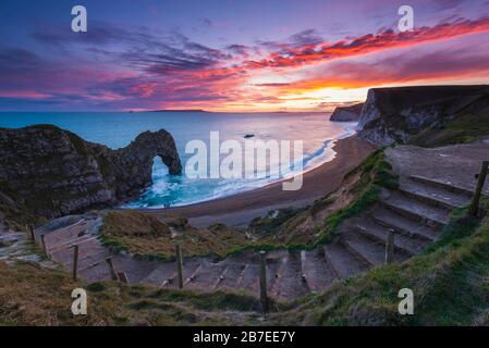 Durdle Door, Lulworth, Dorset, UK.  15th March 2020.  UK Weather.  A spectacular fiery sunset at Durdle Door on the Dorset Jurassic Coast near Lulworth as the cloud clears as high pressure builds in from the South West.  Picture Credit: Graham Hunt/Alamy Live News Stock Photo