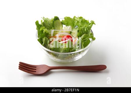fresh green lettuce salad in bowl closeup isolated on white background Stock Photo