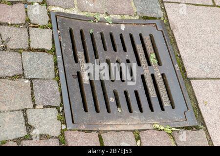 Iron manhole cover for the drainage of the road Stock Photo