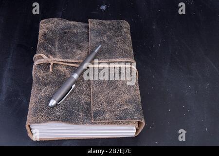 old diary bound in leather with pen and text space Stock Photo