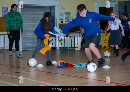 School children in sport game with Laura Brooks form Tackle Africa, Davidsons Mains primary school, Edinburgh, Scotland, UK Stock Photo