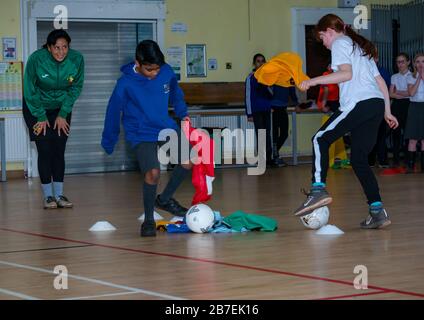 School children in sport game with Laura Brooks form Tackle Africa, Davidsons Mains primary school, Edinburgh, Scotland, UK Stock Photo