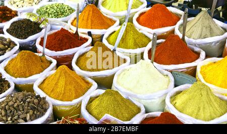 Sacks of different spice powders at an outdoor market Stock Photo