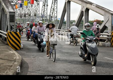 Bicycles and scooters on Trang Tien bridge in Hue, Vietnam Stock Photo