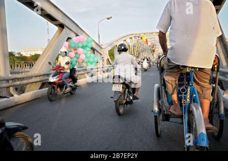 Two-wheeler traffic on Trang Tien bridge in Hue, Vietnam Stock Photo