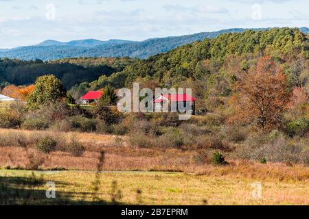 View of red farm houses roof vibrant color in appalachian mountains along highway 220 in Warm Springs, Bath County, Virginia Stock Photo