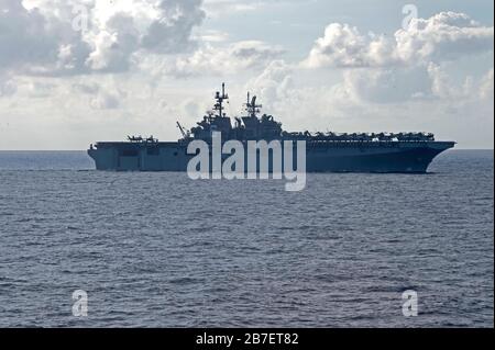 200313-N-WP865-2052  SOUTH CHINA SEA (March 13, 2020) USS America (LHA 6) transits the South China Sea as seen from USS Gabrielle Giffords (LCS 10).  Gabrielle Giffords, part of Commander, Destroyer Squadron Seven, is on a rotational deployment, operating in the U.S. 7th Fleet area of operations to enhance interoperability with partners and serve as a ready-response force. (U.S. Navy photo by Mass Communication Specialist 2nd Class Brenton Poyser/Released) Stock Photo