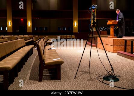 Mar 15, 2020; Springfield, IL, USA; Rev. Roger Grimmett delivers his message to an empty sanctuary and a camera crew for First United Methodist Church's Sunday morning service for the first time due to restrictions of large gatherings because of COVID-19, Sunday, March 15, 2020, in Springfield, Ill. First United Methodist Church live streamed their 9 a.m. traditional service as well as their 10:30 a.m. contemporary service on the church's Facebook page because of the restrictions. It's the first time the church has closed to corporate worship since 1918 at the height of the flu epidemic. M Stock Photo