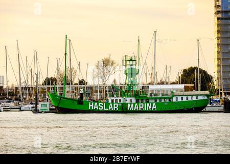 Green lightship Mary Mouse 2 moored at the entrance to Haslar Marina in Portsmouth Harbour viewed from Old Portsmouth, Hampshire, south coast England Stock Photo