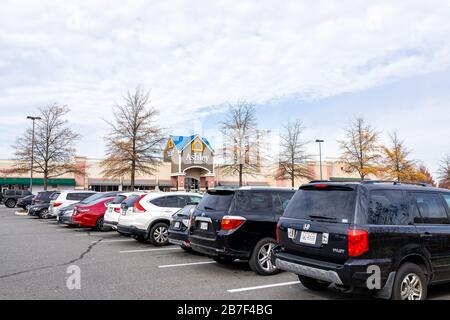 Sterling, USA - November 21, 2019: Ashley homestore store sign by entrance of store in Fairfax county, Virginia with cars in parking lot Stock Photo