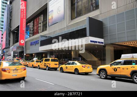 Taxis, suffering a major drop in ridership over coronavirus fears, wait outside Marriott Marquis hotel, theatre, Times Square, NYC, March 15, 2020 Stock Photo