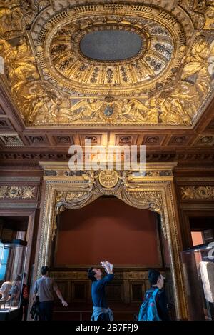 Asian tourist taking a picture of an ornate ceiling at the Louvre Museum in Paris, France, Europe Stock Photo