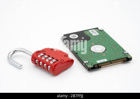 Padlock next to hard disk drive representing data protection and security Stock Photo
