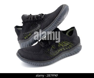 Pair of black Free RN Flyknit ventilated summer running shoes isolated on white background Stock Photo