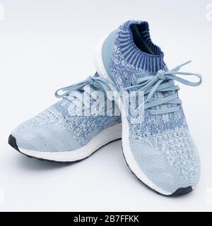Pair of blue uncaged Adidas Ultraboost running shoes cutout isolated on white background Stock Photo