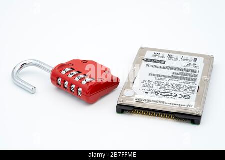 Padlock next to hard disk drive representing data protection and security Stock Photo