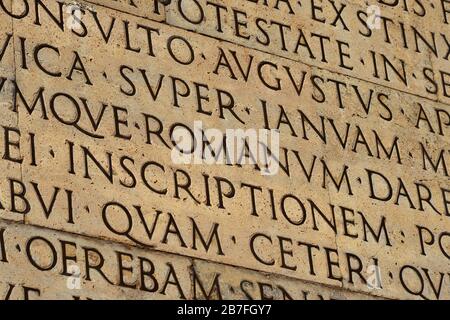 Latin ancient language and classical education. Inscription from Emperor Augustus famous Res Gestae (1st century AD), with the word Romanum in the cen Stock Photo