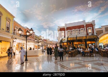 inside the Villaggio Mall in Doha, Qatar - a 'mini Venice' featuring canals, gondolas, and an artificial daytime sky ceiling Stock Photo