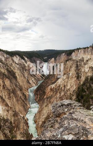 The tall and powerful Lower Falls of the Yellowstone River as it falls into the steep canyon as seen from Artists Point in Yellowstone National Park, Stock Photo