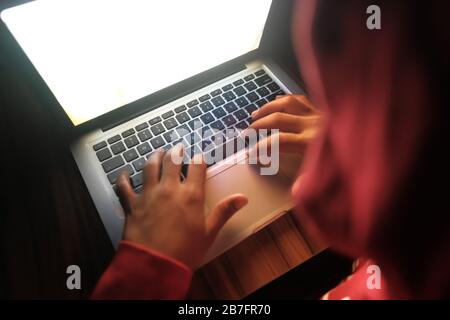 hooded hacker stealing data from laptop  Stock Photo