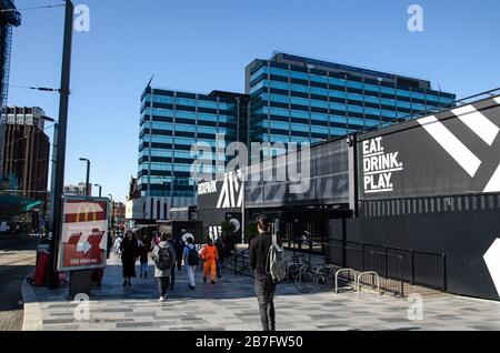 Croydon, UK - October 2, 2019: Pedestrians passing the catering and bar offerings of the Boxpark development in East Croydon on a sunny autumn morning Stock Photo