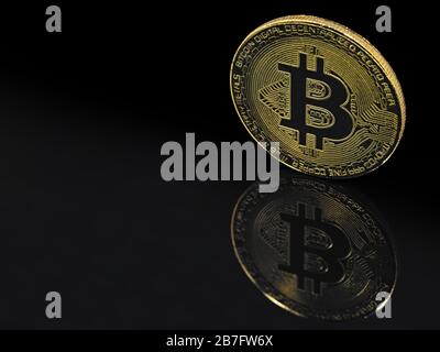 golden bitcoin on black background with reflection and copy space Stock Photo