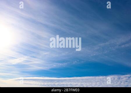Cirrus and Cirrocumulus clouds against the blue sky. Natural background. Atmospheric phenomena. Stock Photo