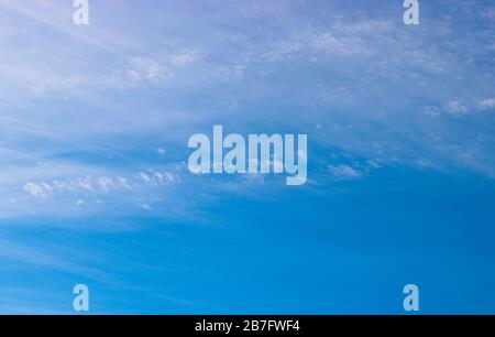Cirrus and Cirrocumulus clouds against the blue sky. Natural background. Atmospheric phenomena. Stock Photo