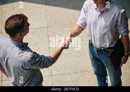 Cropped image of young entrepreneurs shaking hands when greeting each other before meeting Stock Photo