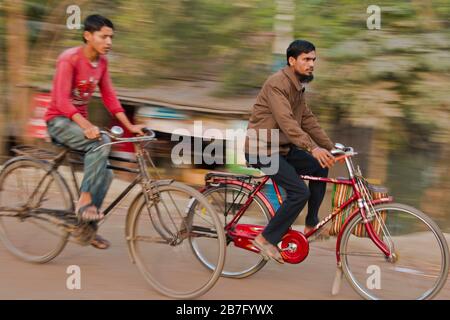 A group of Bangladeshi people traveling by bicycle from the countryside, Bangladesh. Stock Photo