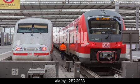 Rear view of two trains at Munich central / main station: An Intercity Express (ICE, second gen,) and a regional (RE) train of Deutsche Bahn (DB). Stock Photo