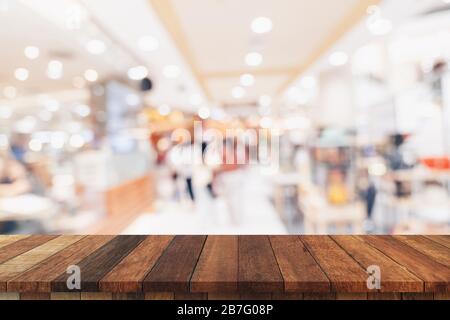 Empty wood table and blurred light table in shopping mall with bokeh background. product display template. Stock Photo