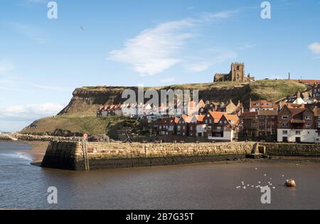 The historic Tate Hill Pier and St Marys Church in Whitby, North Yorkshire, England, UK Stock Photo