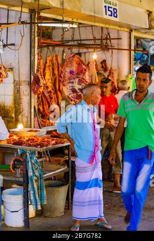 South Asia Sri Lanka Kandy Sinhala Central Province ancient capital food Municipal Central Market butcher meat on red hook rail signs table Stock Photo