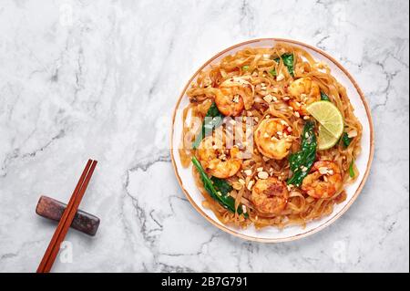 Prawn Pad See Ew on white marble background. Pad See Ew is thai cuisine dish with rice noodles, prawns, soy and oyster sauces and greens. Thailand foo Stock Photo