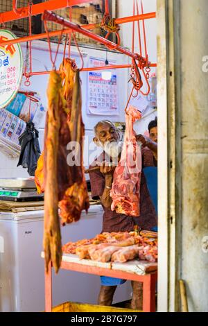 South Asia Sri Lanka Kandy Sinhala Central Province ancient capital food Municipal Central Market butcher meat on red hook rail signs table fridge Stock Photo