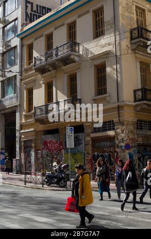 ATHENS, GREECE - 03 Mar 2020 - People crossing a busy thoroughfare in central Athens Greece Stock Photo