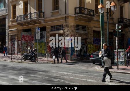 ATHENS, GREECE - 03 Mar 2020 - People crossing a busy thoroughfare in central Athens Greece Stock Photo