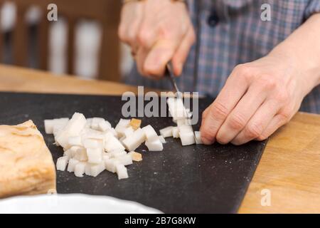 Making bavarian white sausages at home, cutting lard Stock Photo