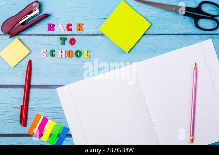 Layout of school supplies on a blue wooden background. The view from the top. Back to school. Flat lay Stock Photo