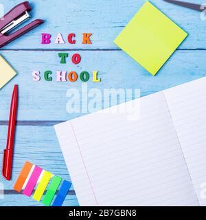 Layout of school supplies on a blue wooden background. The view from the top. Back to school. Flat lay Stock Photo
